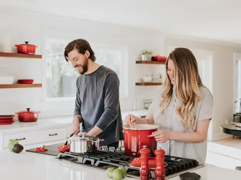A couple cooking together in their family kitchen